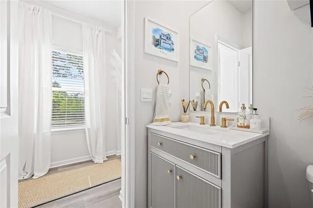 a bathroom with a sink a mirror and a window