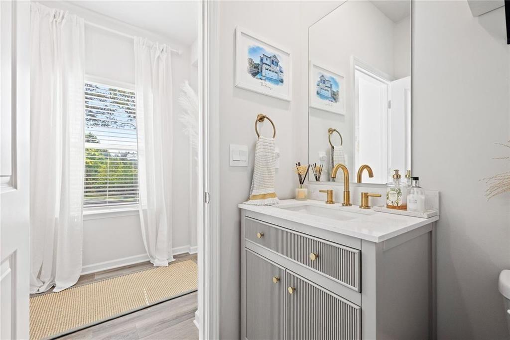 4167 Waratah Way Mableton, GA 30126 - Photo 11 of 32 a bathroom with a sink a mirror and a window