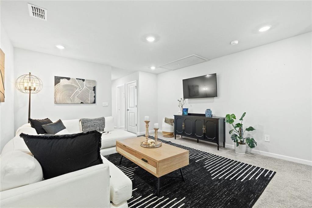 4167 Waratah Way Mableton, GA 30126 - Photo 12 of 32 a living room with furniture and a flat screen tv