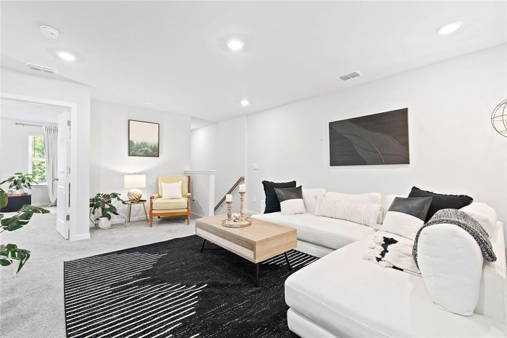 4167 Waratah Way Mableton, GA 30126 - Photo 13 of 32 a living room with furniture and a flat screen tv
