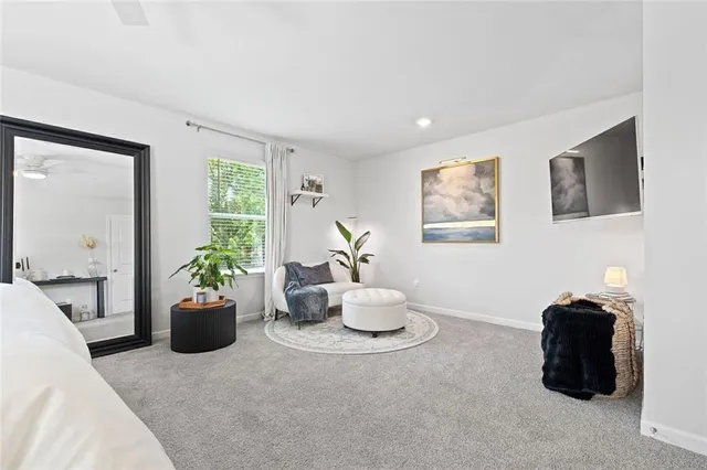 a living room with furniture potted plant and a window