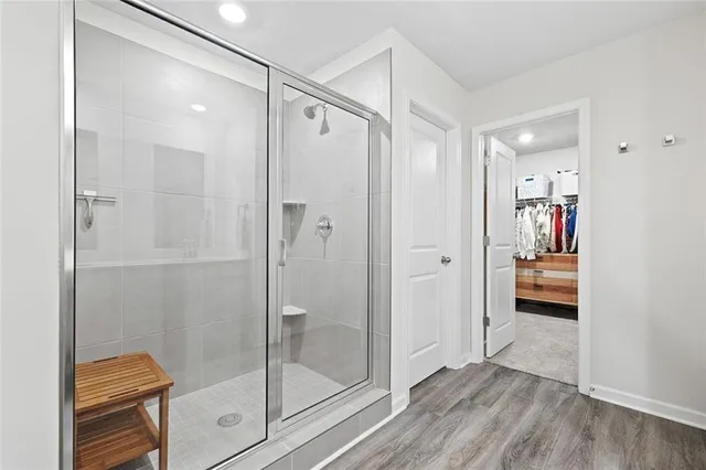 a bathroom that has a glass shower door