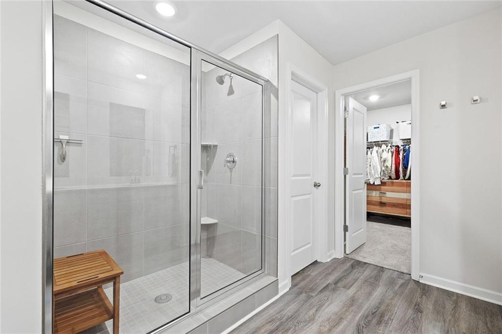 4167 Waratah Way Mableton, GA 30126 - Photo 17 of 32 a bathroom that has a glass shower door