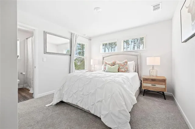 a bedroom with a bed and a painting