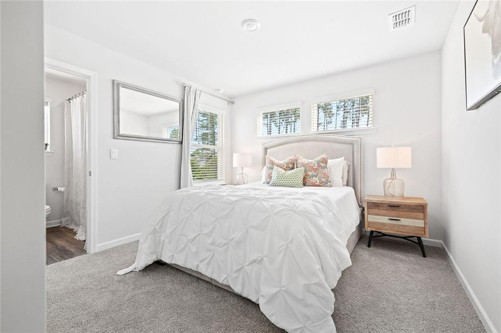 4167 Waratah Way Mableton, GA 30126 - Photo 19 of 32 a bedroom with a bed and a painting