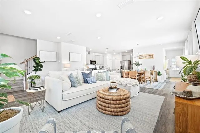 a living room with furniture and a potted plant