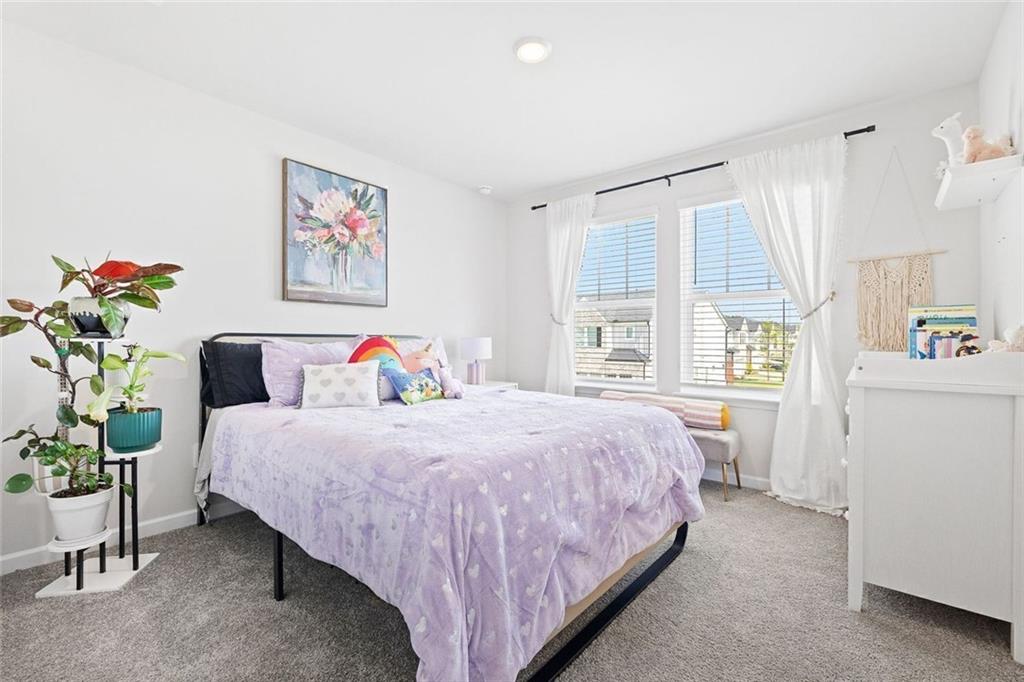 4167 Waratah Way Mableton, GA 30126 - Photo 21 of 32 a bedroom with a bed dresser and a window