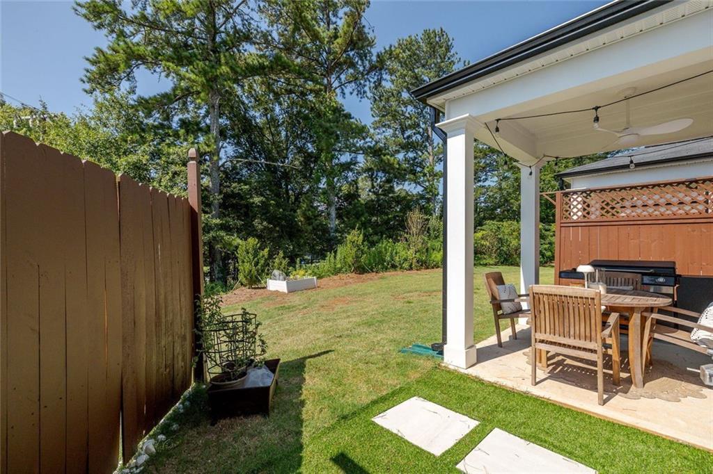 4167 Waratah Way Mableton, GA 30126 - Photo 24 of 32 a view of a chair and table in backyard of the house