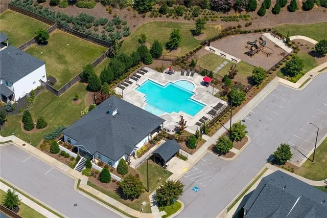 an aerial view of a house with a yard
