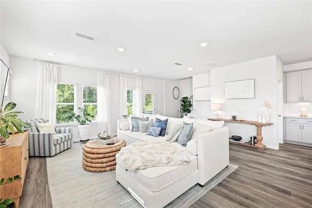 a living room with furniture and wooden floor