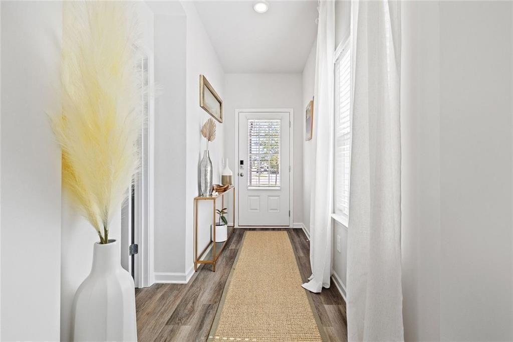 4167 Waratah Way Mableton, GA 30126 - Photo 10 of 32 a view of a hallway with wooden floor and staircase