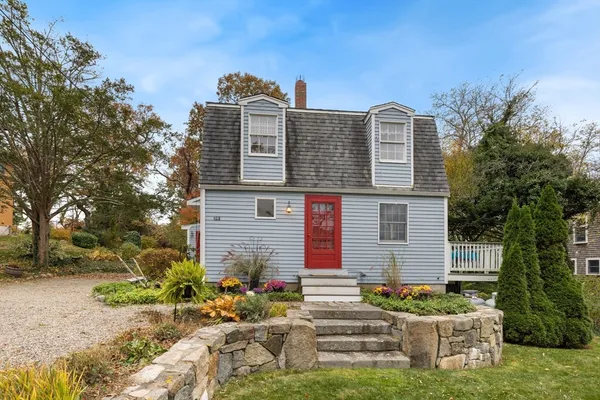 a front view of a house with a garden