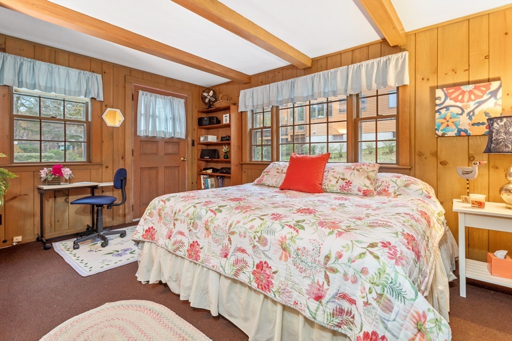 26 Coggeshall Road Gloucester, MA 01930 - Photo 13 of 37 a bedroom with a bed dresser and a large window