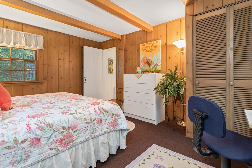 26 Coggeshall Road Gloucester, MA 01930 - Photo 14 of 37 a bedroom with a bed and a potted plant