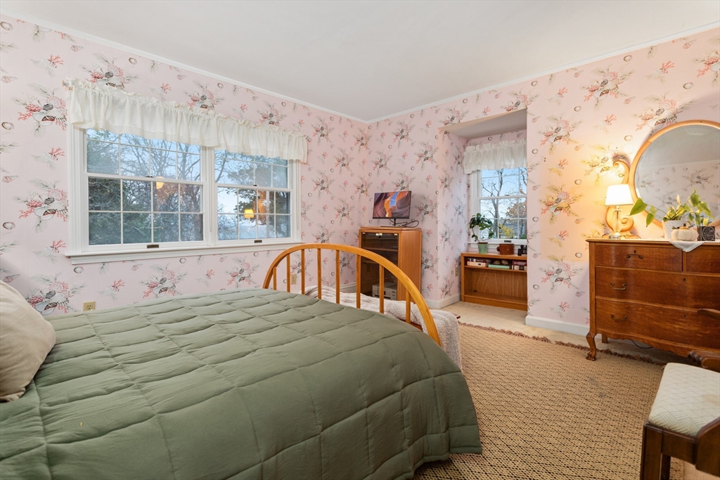 26 Coggeshall Road Gloucester, MA 01930 - Photo 17 of 37 a bedroom with a bed and a window