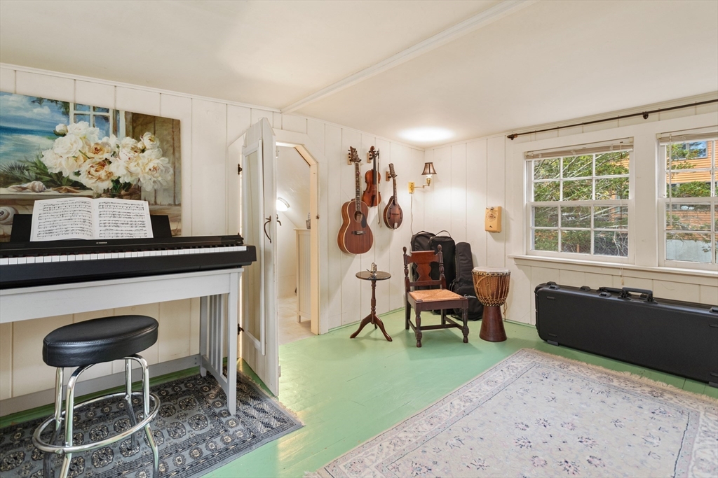 26 Coggeshall Road Gloucester, MA 01930 - Photo 18 of 37 a living room with furniture a flat screen tv and a fireplace
