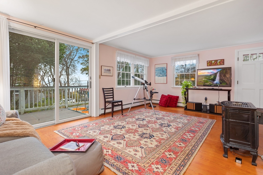 26 Coggeshall Road Gloucester, MA 01930 - Photo 3 of 37 a living room with furniture a rug and a flat screen tv