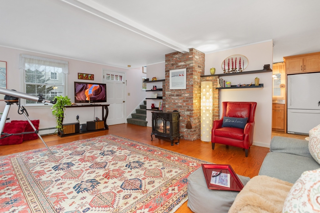 26 Coggeshall Road Gloucester, MA 01930 - Photo 4 of 37 a living room with furniture and a flat screen tv