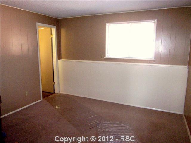 7092 Chippewa Road Colorado Springs, CO 80915 - Photo 15 of 16 One of Two Lower Level Bedrooms, has Mid-Toned Neutral Walls, Carpet & Adjoining Bath