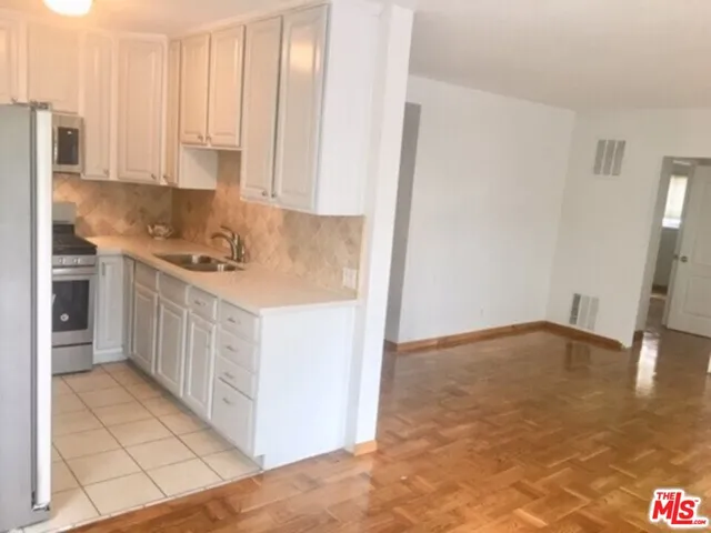 a kitchen with a stove a sink and a refrigerator
