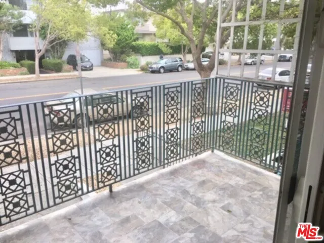 a view of a street with wooden fence
