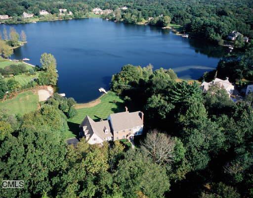 47 Cavalry Road Weston, CT 06883 - Photo 1 of 1 an aerial view of a house with a yard and lake view