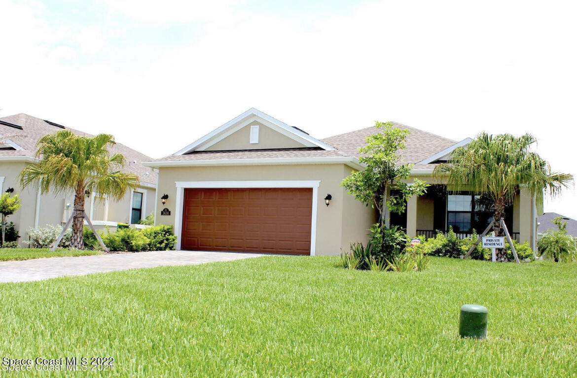 a front view of house with yard and green space