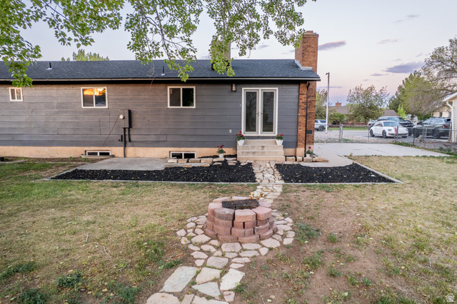 634 South 2100th Street West Vernal, UT 84078 - Photo 71 of 71 Backyard featuring a stone fire pit, flagstone pathway, and a patio with direct access to the interior via double French doors