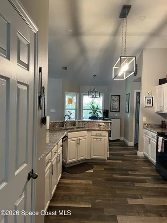 a kitchen with a sink and refrigerator