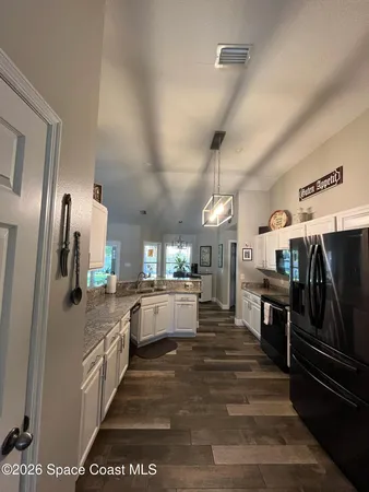a large kitchen with stainless steel appliances kitchen island granite countertop a large counter top cabinets and stainless steel appliances