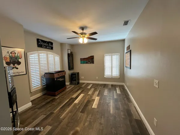 a view of livingroom with hardwood floor and a ceiling fan
