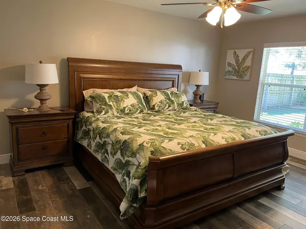 a bed sitting in a bedroom next to a window