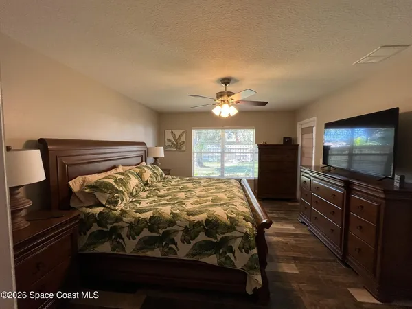 a bed sitting in a bedroom and furniture