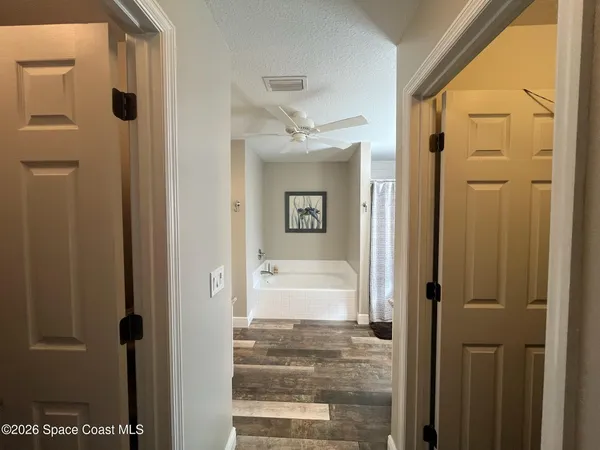a bathroom with a tub shower and a sink