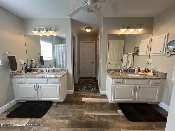 a bathroom with a sink vanity and a mirror