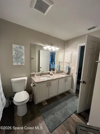 a bathroom with a sink toilet and a mirror