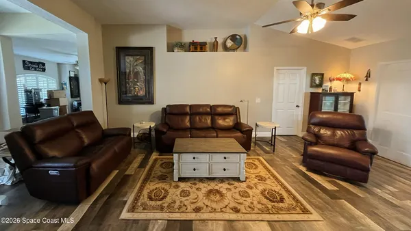 a living room with furniture and wooden floor