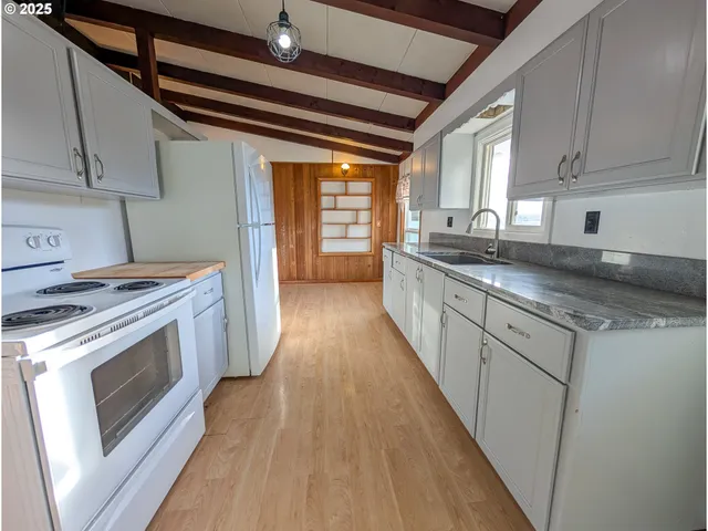 a kitchen with sink stove and cabinets