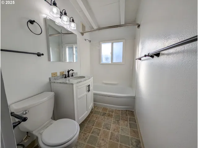 a bathroom with a toilet sink and shower