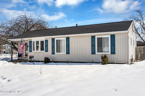 a view of a house with a large window and potted plants