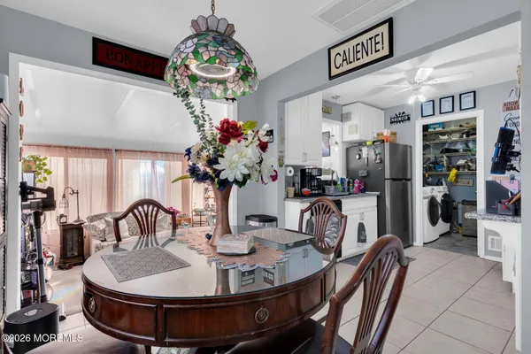 a dining room with furniture and chandelier