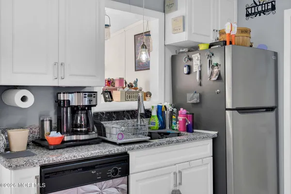 a kitchen with refrigerator and cabinets