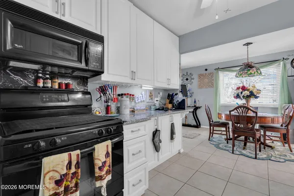 a kitchen with stainless steel appliances granite countertop a stove and cabinets