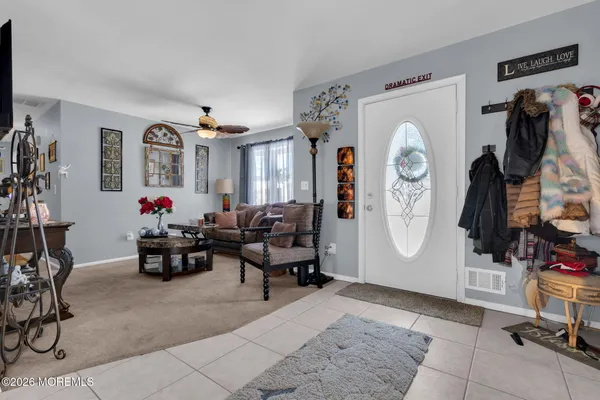 a living room with furniture a window and a flat screen tv