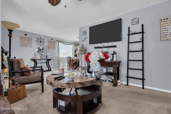 a living room with furniture a flat screen tv and a flat screen tv