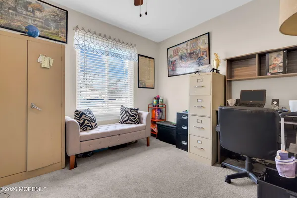 a view of a livingroom with workspace and a window