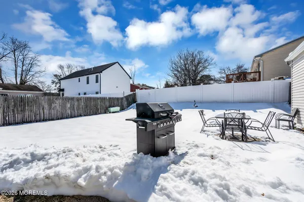 a view of a backyard with snow on the roof