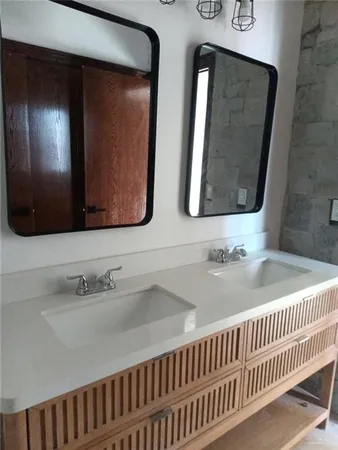 a bathroom with two sinks and a mirror