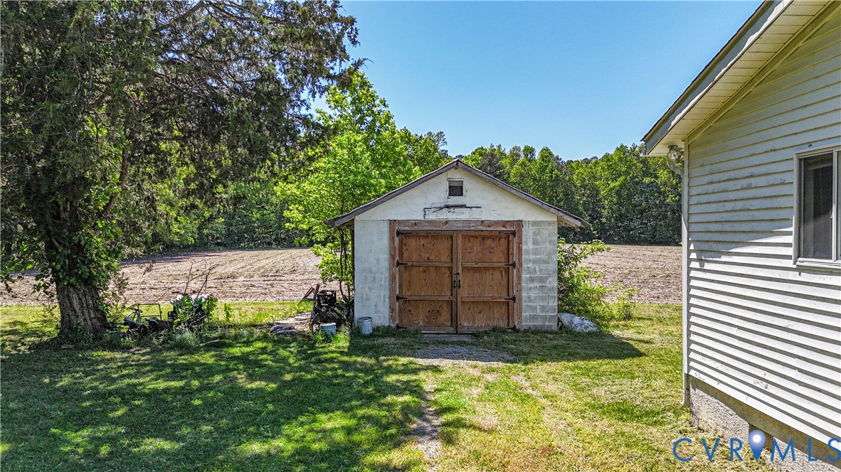 5134 Beechland Road Elberon, VA 23846 - Photo 4 of 21 a house with trees in front of it