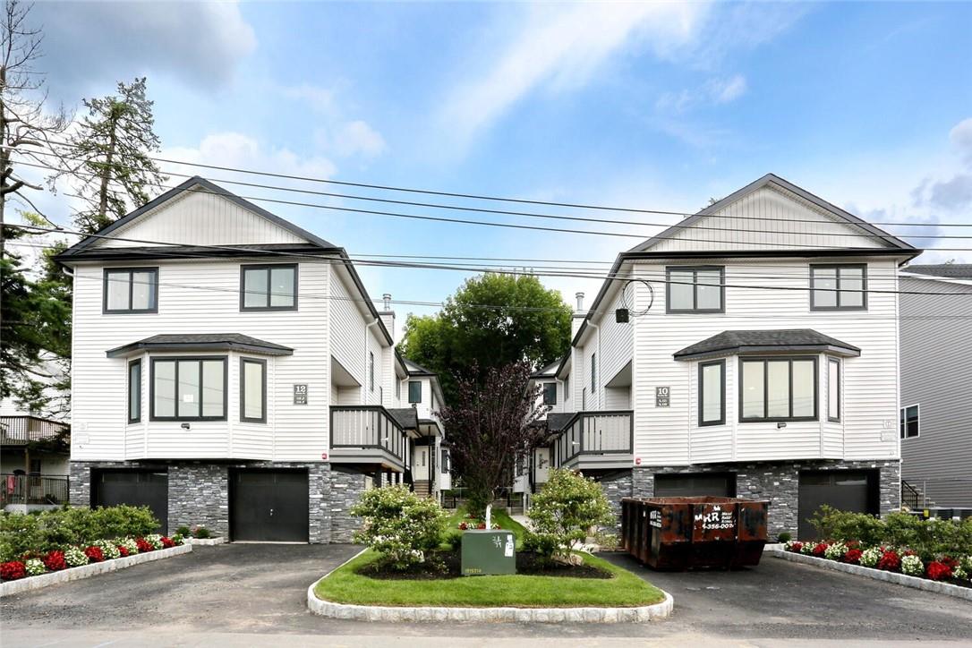 10 Parker Street, Unit 111 Spring Valley, NY 10977 - Photo 1 of 1 a front view of a house with garden